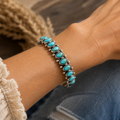 Turquoise beaded bracelet on a wrist with a blurred background
