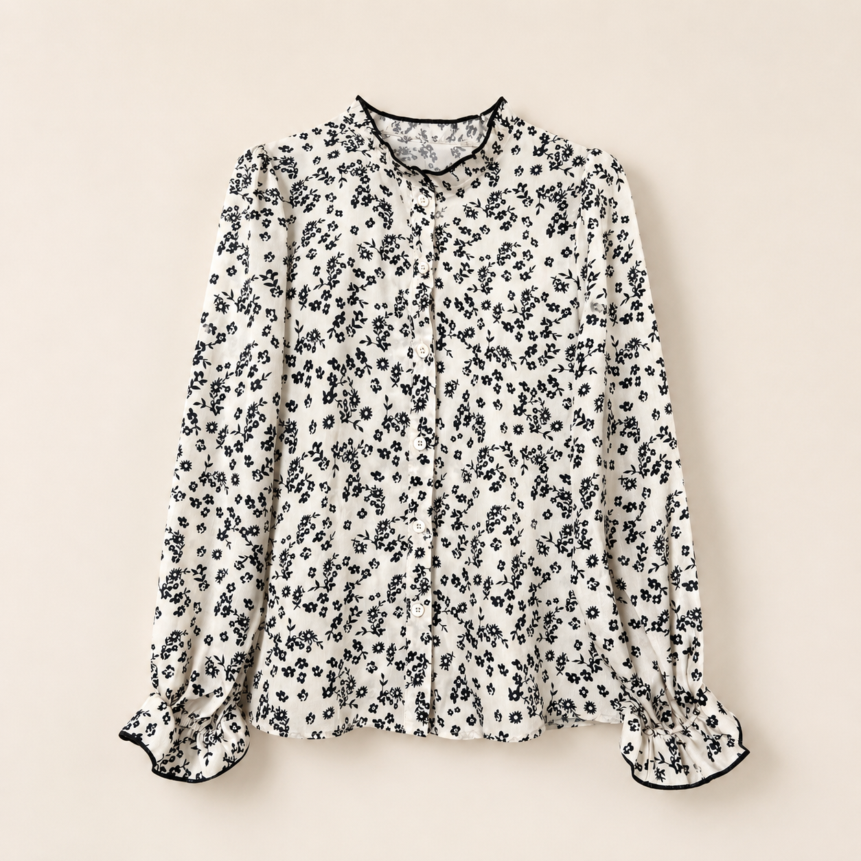 Floral patterned blouse on a beige background