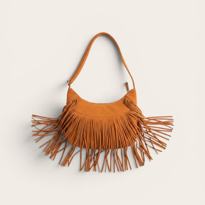 Brown suede handbag with fringe details on a light beige background